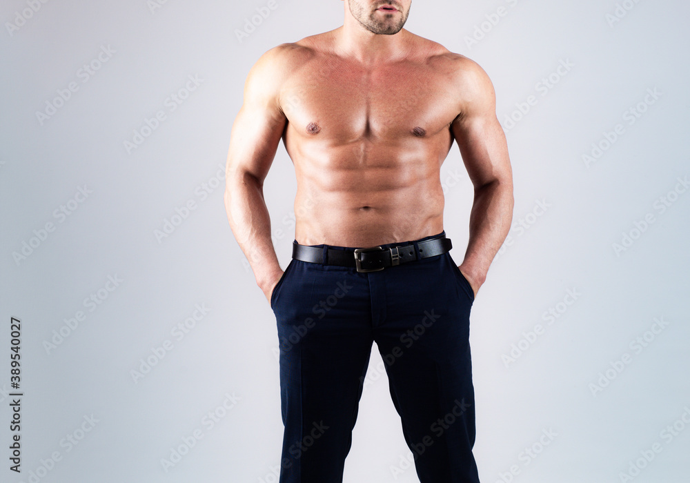 Fototapeta premium Athletic guy flexing muscles. Abdominal muscle, man abs, six pack. Guy with a naked torso.