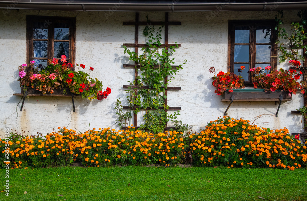 facade of a traditional farmhouse with flower decoration in the Austria region of Carinthia