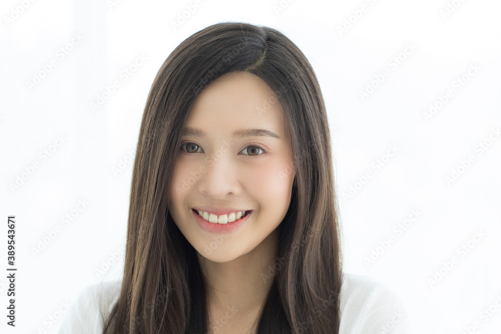 Portrait of beautiful and cute long hair Asian woman standing and looking to camera with a wild and warm smile on her face Portrait of beautiful and cute long hair Asian woman standing and looking to camera with a wild and warm smile on her face