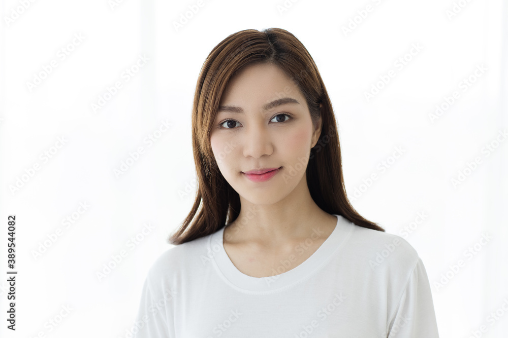 Portrait of beautiful and cute long hair Asian woman standing and looking to camera with a wild and warm smile on her face Portrait of beautiful and cute long hair Asian woman standing and looking to camera with a wild and warm smile on her face