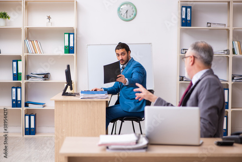 Two male colleagues working in the office