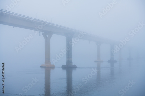 Bridge over the river in heavy fog © SGr