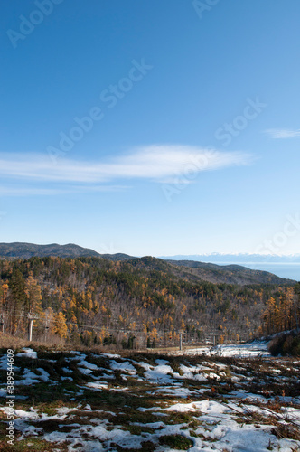 Baikal lake fresh water flora shore reserve Russia Irkutsk park island Sky clouds clear Olkhon rocks trees embankments sand bay lagoon stones mountains hills horizon line panorama autumn water waves t