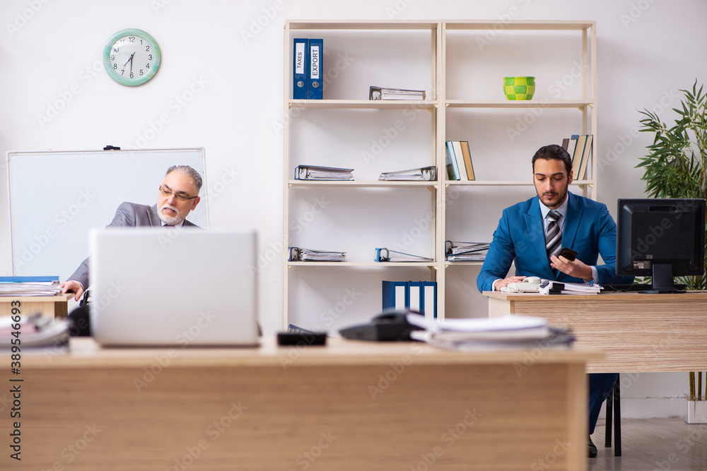Two male colleagues working in the office Two male colleagues working in the office