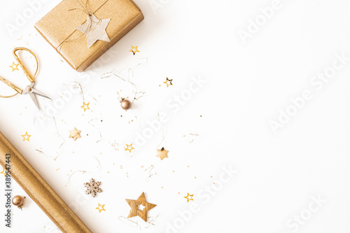 Christmas composition. Gift box, golden decorations on white background. Christmas, winter, new year concept. Flat lay, top view