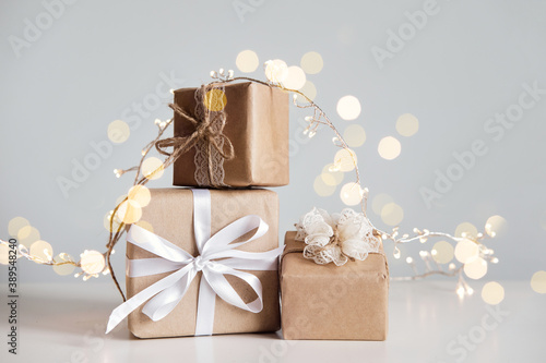 Christmas zero waste. Eco friendly packaging gifts in kraft paper and garland photo