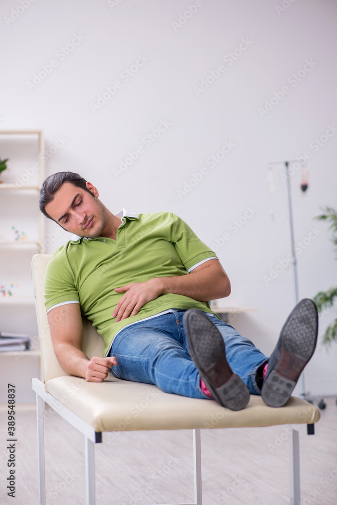 Young man waiting for doctor in the clinic