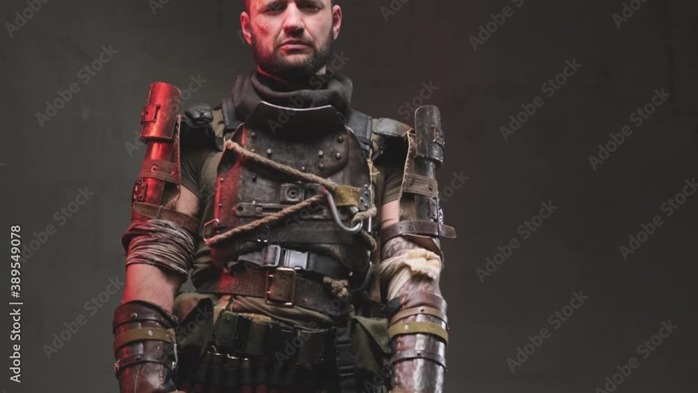 Camera shooting moving from the top down serious and mature military he stays holding his self made shotgun and looking at camera. Camera shooting moving from the top down serious and mature military he stays holding his self made shotgun and looking at camera.