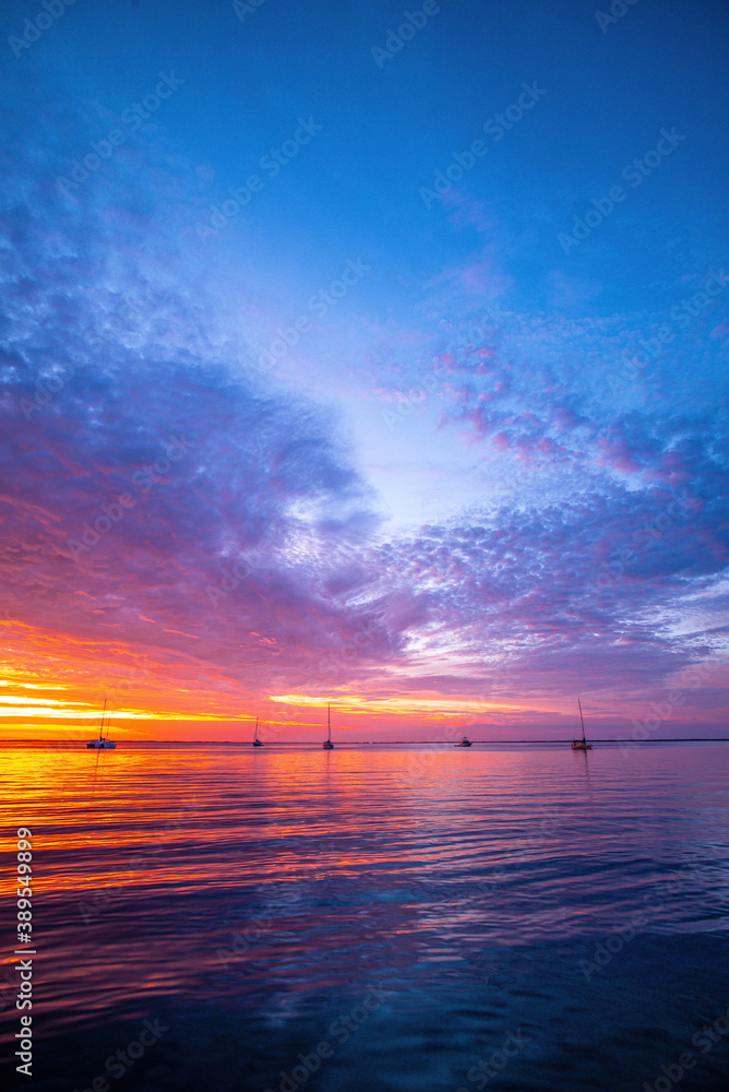 Fototapeta premium Sunset sea beach. Blue sea and reflection of sunlight.