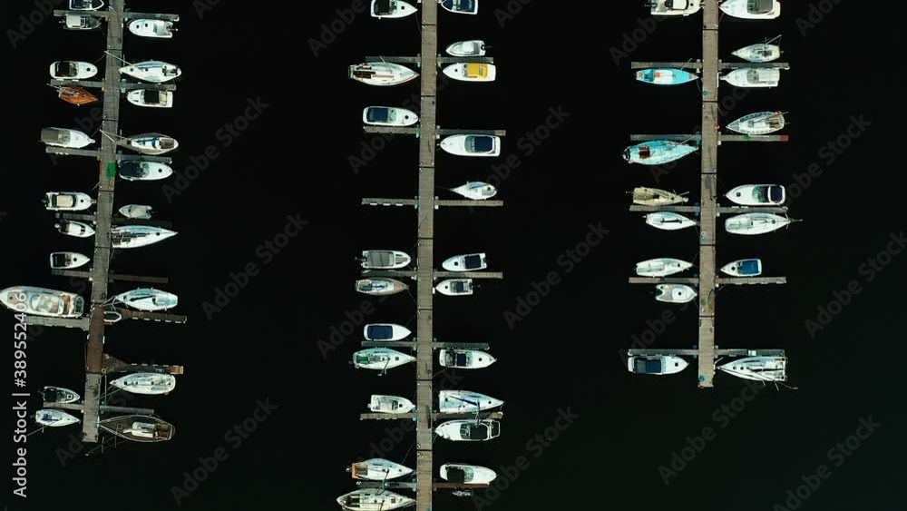 Close-up, boats are moored at the boat station. View from a copter, seaport, boat station, boats are in rows. Close-up, boats are moored at the boat station. View from a copter, seaport, boat station, boats are in rows.