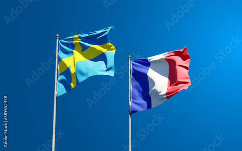 Beautiful national state flags of France and Sweden together at the sky background. 3D artwork concept.