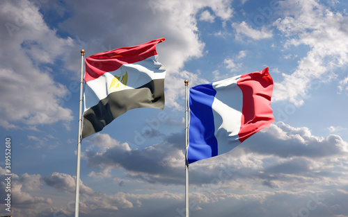 Beautiful national state flags of France and Egypt together at the sky background. 3D artwork concept.