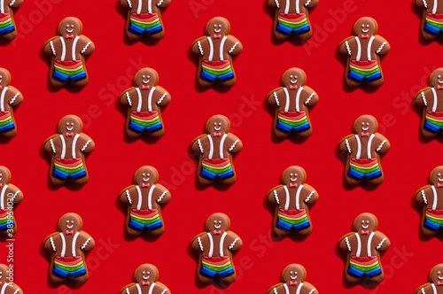 Lgbt pride. Red seamless background. Diversity tolerance. Bakery food art conceptual ornament. Happy African gay gingerbread man biscuit in rainbow shorts minimalist composition isolated on bright.