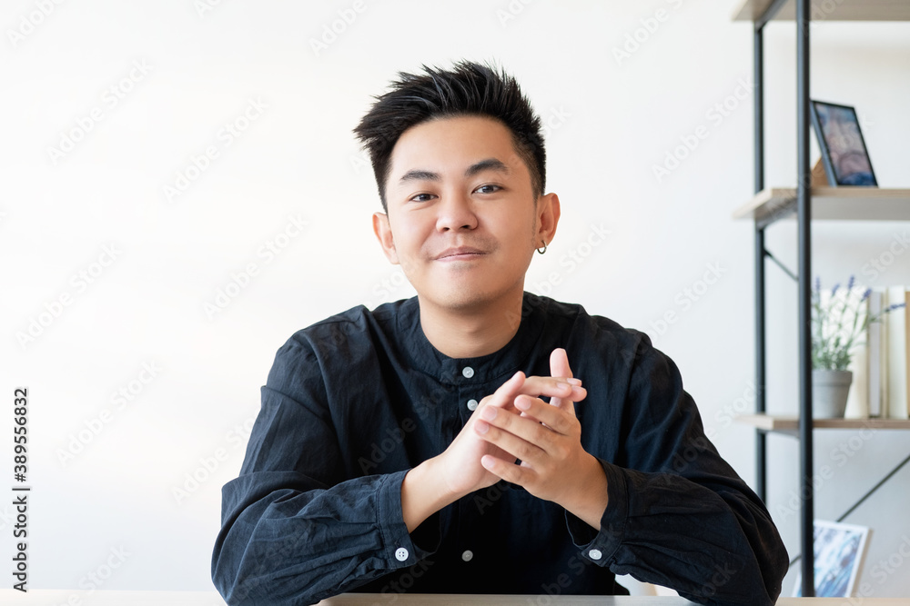 Successful project. Business presentation. Portrait of confident proud asian male CEO applauding looking at camera at light home office with white copy space background.