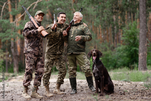Fotografie, Obraz Carefree Hunters in Forest Weekend Together.
