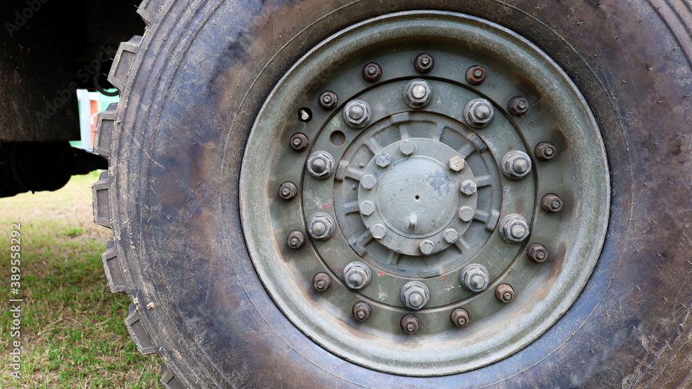 Nut with bolts and tire wheels. Big wheel cargo semi truck with copy space. Close focus and select an object Nut with bolts and tire wheels. Big wheel cargo semi truck with copy space. Close focus and select an object