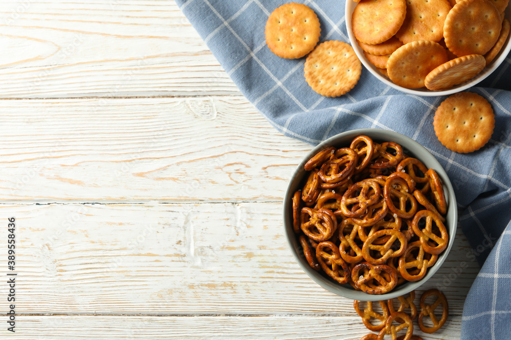 Napkin and bowls with cracker biscuits on wooden background Napkin and bowls with cracker biscuits on wooden background