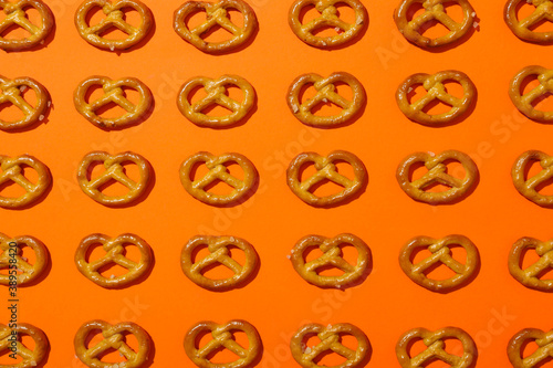 Flat lay with cracker pretzels on orange background