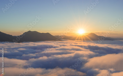beautiful sunrise over mountain with fog in the morning