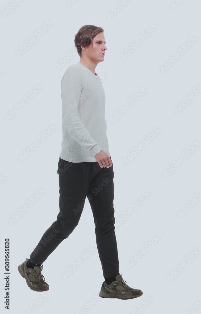 in full growth. confident young man striding forward. in full growth. confident young man striding forward.