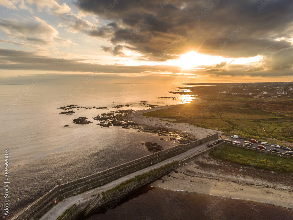 Aerial drone view on a Spiddal stone pier. County Galway, Ireland. Atlantic ocean, Sunset time. Dramatic sky.