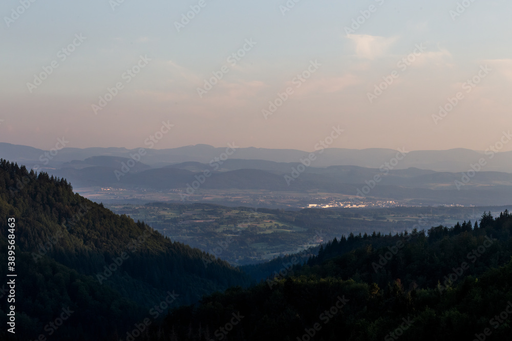 Panorama at sunset from the mountains of the Black Forest near Gersbach over the Wehratal and the city of Wehr towards the Swiss Alps Panorama at sunset from the mountains of the Black Forest near Gersbach over the Wehratal and the city of Wehr towards the Swiss Alps