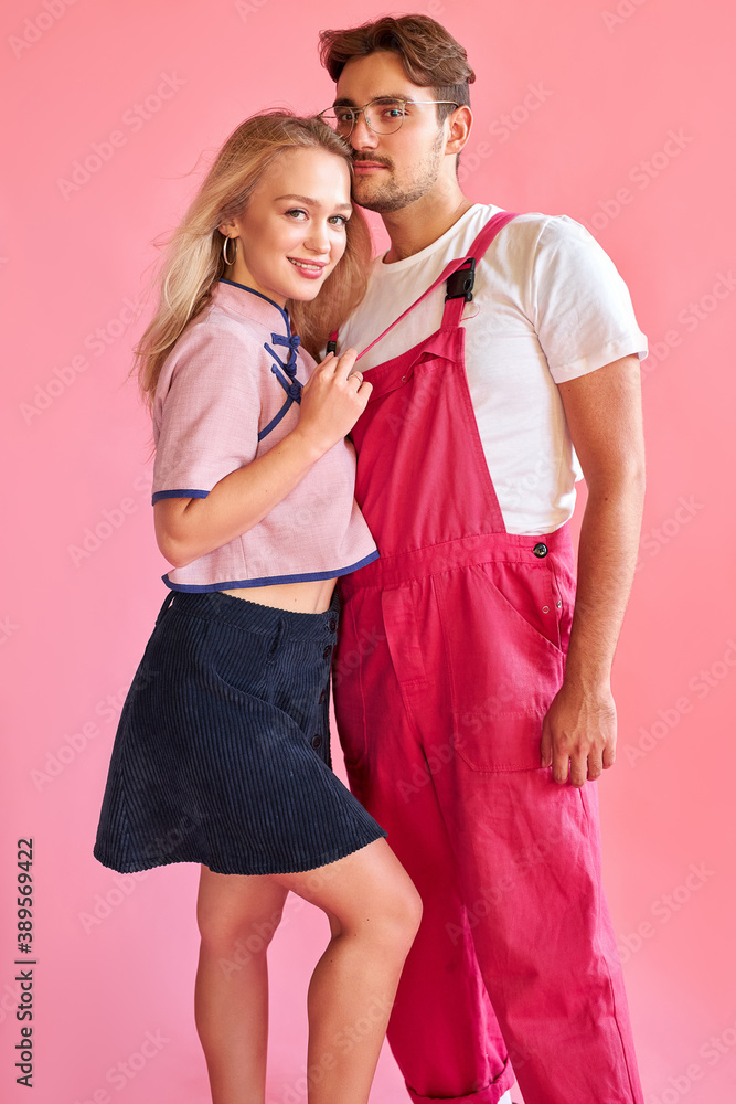 cute caucasian couple isolated over pink background, young man and woman are in love, they have harmonious relationships cute caucasian couple isolated over pink background, young man and woman are in love, they have harmonious relationships