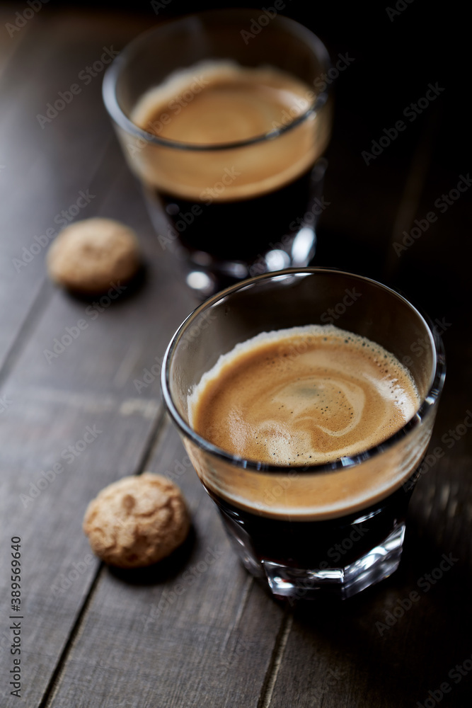 Two Glasses Of Coffee on dark wooden background. Close up. Two Glasses Of Coffee on dark wooden background. Close up.