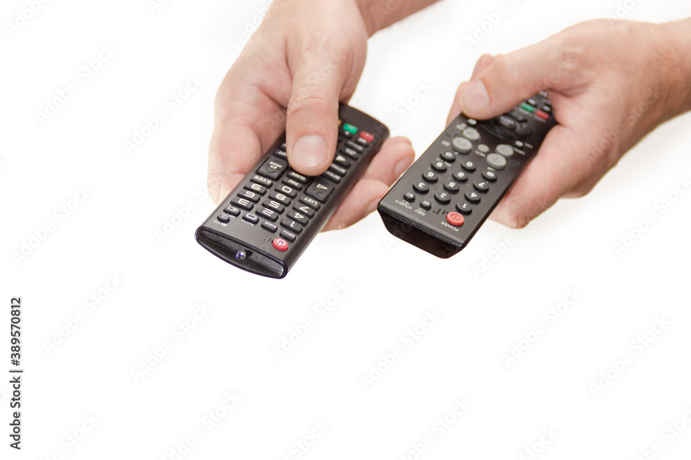 Two remote controllers in man's hands on white background Two remote controllers in man's hands on white background