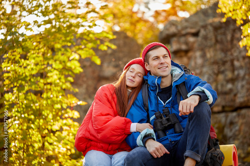 caucasian couple enjoy vacation or weekend in the forest on mountains, beautiful man and woman spend leisure time, hike in the weekends, nature background