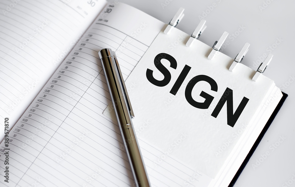 text SIGN on the short note texture background with pen text SIGN on the short note texture background with pen