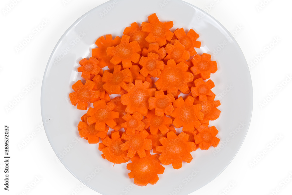 Top view of figured chopped carrots on white dish, fragment Top view of figured chopped carrots on white dish, fragment