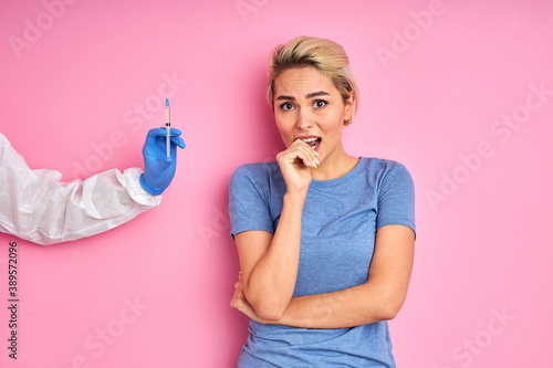 male doctor giving vaccine shot to frightened caucasian woman  female is afraid of injections. prevention  protection and immunization concept