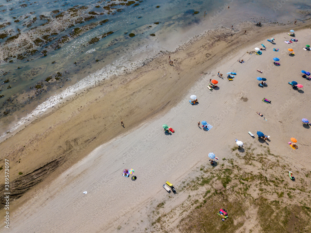 Aerial view of unidentifiable people enjoying summer at the beach of Grado in the province of Gorizia at the Northern Adriatic Sea.