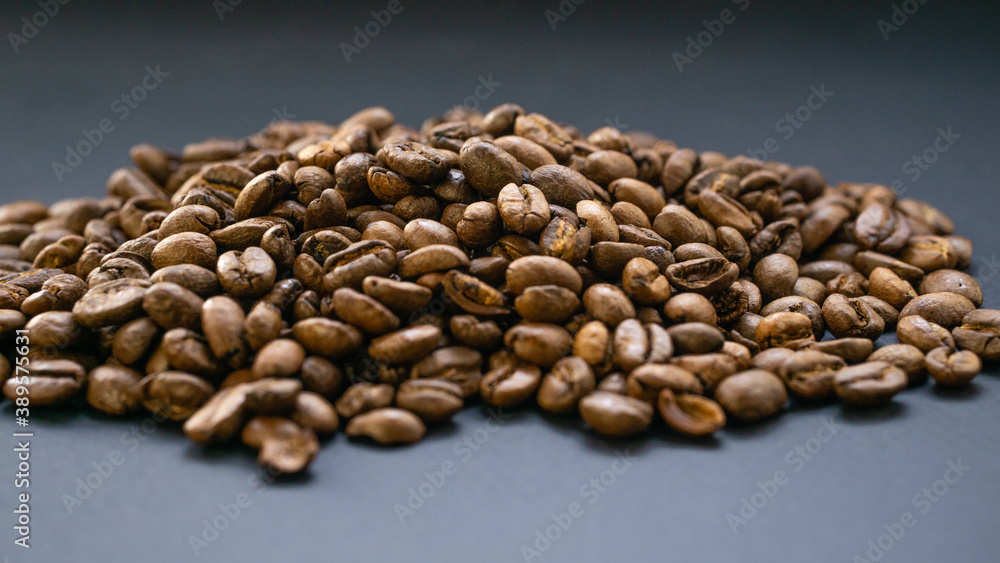 Fototapeta premium Coffee is filled with a slide on a dark, flat surface. Morning sip of energy in a dark drink.