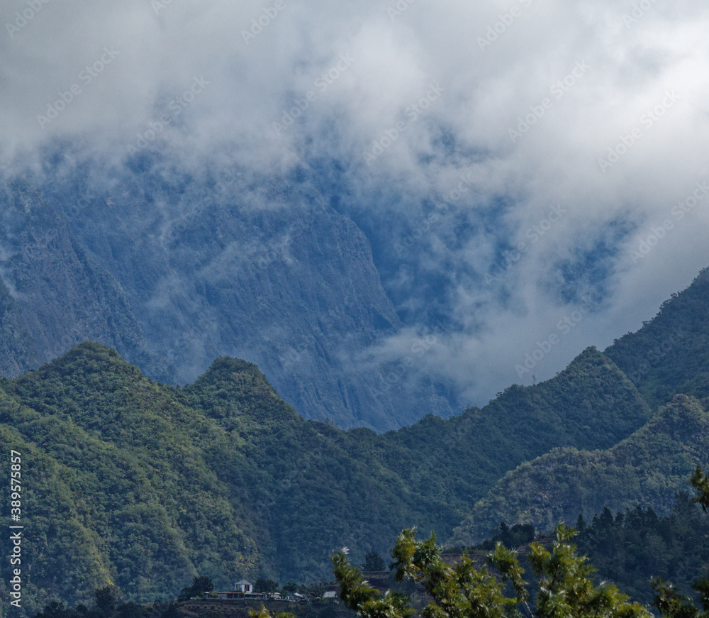 Mist and cloud at the edge of the green volcanic crates and hills of Piton ds Neiges in Reunion island on Indian Ocean. It is hard to reach by human.