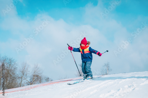 happy cute girl ski in winter nature, kids seasonal sport