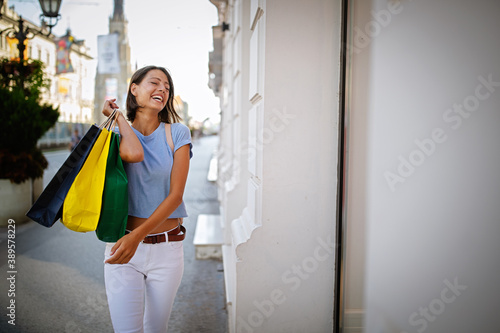 Beautiful shopping woman happy holding shopping bags.