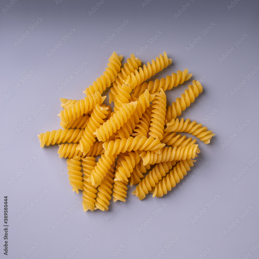 fusilli pasta on gray background close up, isolated fusilli pasta on gray background close up, isolated