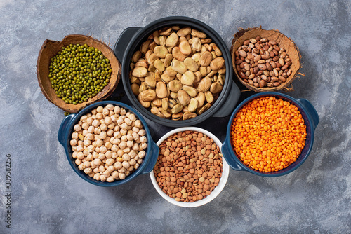 Various assortment of legumes beans, chickpeas, lentils, green peas. Healthy eating concept. Vegetable proteins. concrete background copy space top view 