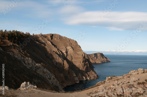 Baikal lake fresh water flora shore reserve Russia Irkutsk park island Sky clouds clear Olkhon rocks trees embankments sand bay lagoon stones mountains hills horizon line panorama autumn water waves 