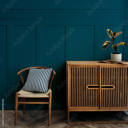 Fotografering Scandinavian vintage wood cabinet with chair by a dark blue wall