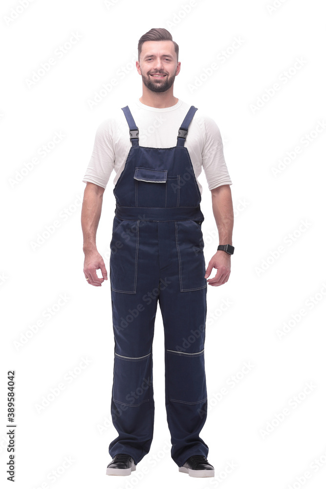 confident young man in blue overalls . isolated on white confident young man in blue overalls . isolated on white