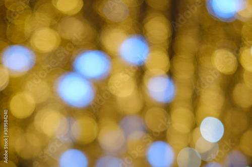 Blurred golden background of christmas lamps, bokeh of city new year light