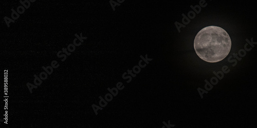 Obraz na płótnie Pleine lune blanche sur ciel nocturne avec des nuages – phénomène céleste saisis