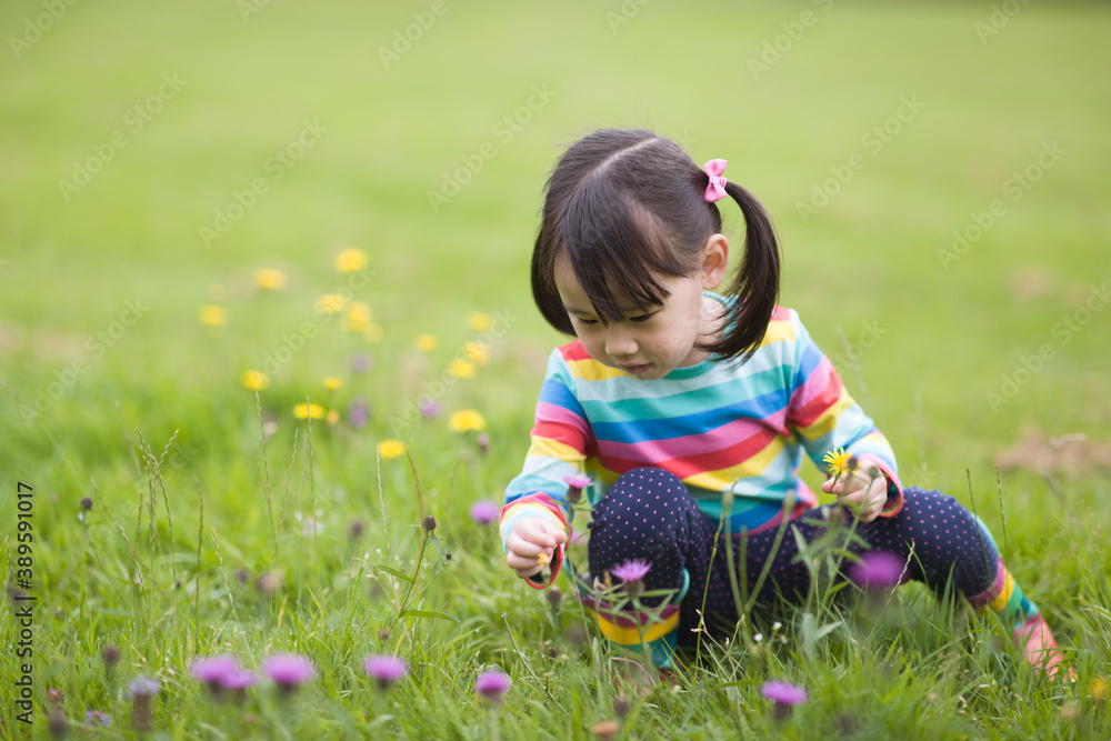 young girl playing in the summer forest park