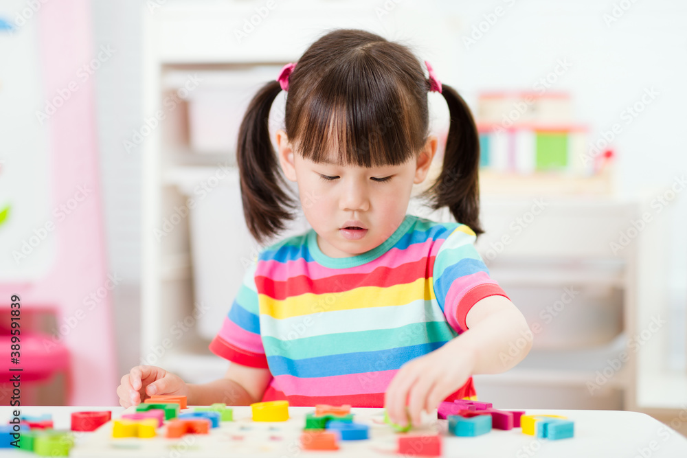 young girl learning letter blocks for homeschooling young girl learning letter blocks for homeschooling