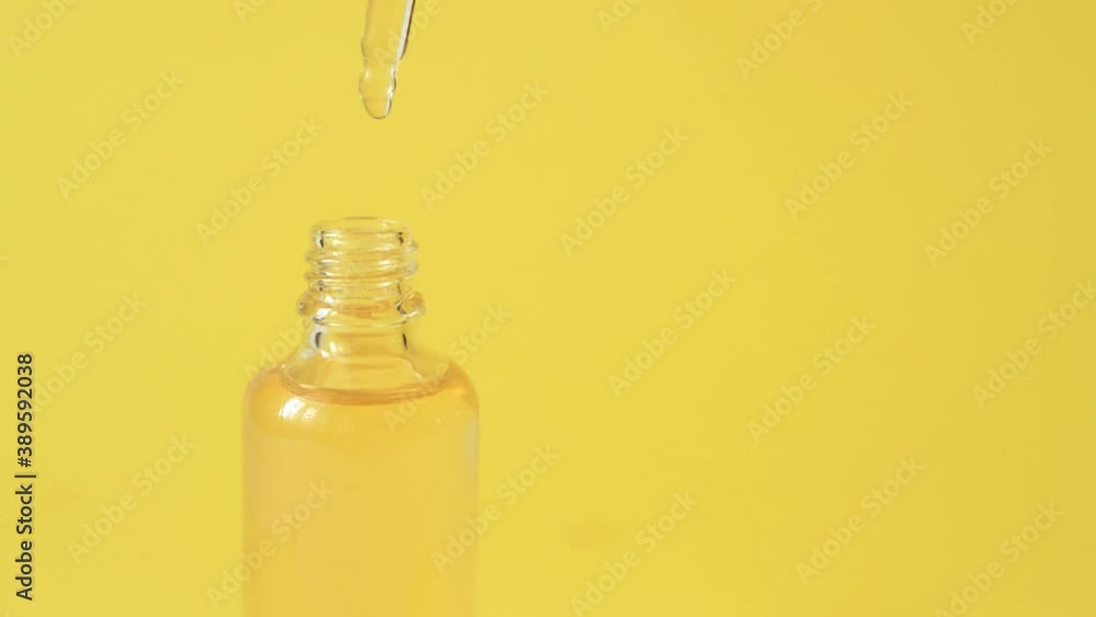 Cosmetic yellow oil on a yellow background. Cosmetic yellow oil on a yellow background.