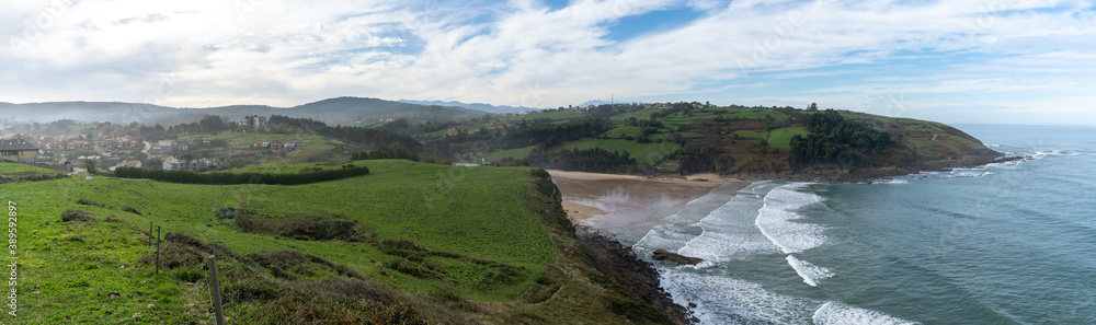 view of the coast and beach at Cobreces village in Cantabria in northern Spain