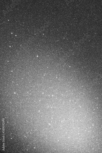Gray background with sparkles and spot of light
